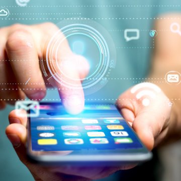 identity guard identity theft protection service mobile app features person typing on smartphone